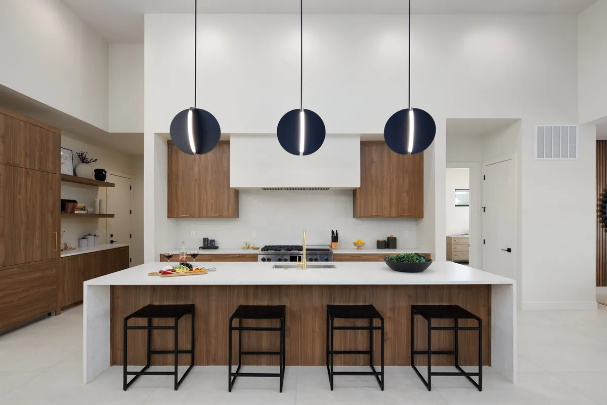 A contemporary kitchen with a central island, pendant lights, and a well-equipped cooking area. The space is inviting for entertaining, family meals, or casual gatherings, reflecting a harmonious blend of elegance and practicality.